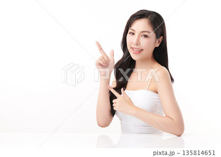 A beautiful young Asian woman with clean, fresh skin against a white background. Skincare, facial treatment, cosmetology, beauty, and spa. An elegant portrait of an Asian woman. A beautiful young Asian woman with clean, fresh skin against a white background. Skincare, facial treatment, cosmetology, beauty, and spa. An elegant portrait of an Asian woman. 135814651
