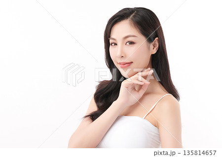 A beautiful young Asian woman with clean, fresh skin against a white background. Skincare, facial treatment, cosmetology, beauty, and spa. An elegant portrait of an Asian woman. 135814657