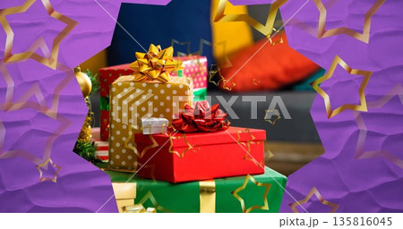Image of stars floating over christmas presents 135816045