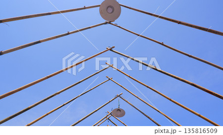 Low Angle View of Bamboo Frame and Outdoor Lamps 135816509