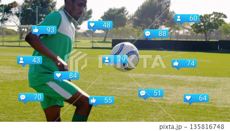 Juggling soccer player controlling white-blue ball thigh-high on turf, with media icons, copy space 135816748