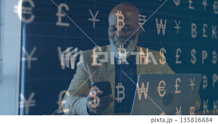 Checking smartphone, mature man analyzing market at office desk, with laptop and currency symbols 135816884