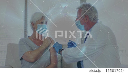 Injecting doctor with gloves giving vaccine to patient on sofa in clinic room, featuring syringe Injecting doctor with gloves giving vaccine to patient on sofa in clinic room, featuring syringe 135817024