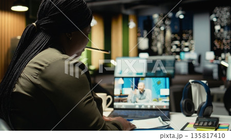 General manager meeting with the CEO on web teleconference after hours in the office, sharing data and insight for company transparency. Briefing late at night due to different time zones. Camera A. 135817410