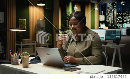 Focused businesswoman reflecting on a business strategy puzzle, envisioning creative concepts and projecting future outcomes. Deep contemplation to inspire a new perspective on the problem. Camera A. 135817423