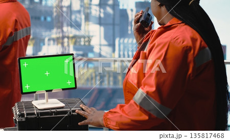 Isolated screen tablet used by offshore platform worker supervising production activity on oil rig deck. Drilling rig employee doing maintenance with chroma key device device Isolated screen tablet used by offshore platform worker supervising production activity on oil rig deck. Drilling rig employee doing maintenance with chroma key device device 135817468