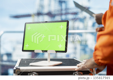 Green screen mockup tablet used by drilling rig worker to evaluate ocean contamination prevention systems. Environmental protection expert monitors carbon footprint with chroma key device, closeup Green screen mockup tablet used by drilling rig worker to evaluate ocean contamination prevention systems. Environmental protection expert monitors carbon footprint with chroma key device, closeup 135817565