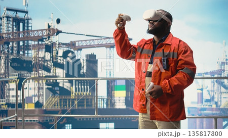 Offshore rig worker supervising deck operations using virtual reality simulation, ensuring compliance with safety protocols. Engineer doing checkup on drilling rig with VR goggles, Offshore rig worker supervising deck operations using virtual reality simulation, ensuring compliance with safety protocols. Engineer doing checkup on drilling rig with VR goggles, 135817800