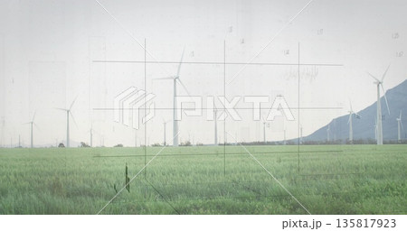 Featuring wind turbine spinning above grassland at wind farm, with mountain ridge, grid overlay Featuring wind turbine spinning above grassland at wind farm, with mountain ridge, grid overlay 135817923