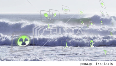 Floating translucent wind turbine, recycling and electric plug icons drifting above waves under sky 135818310