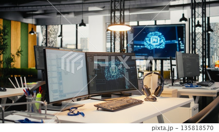 Computer monitors in empty startup workspace with cloud computing AI resources. PC screens in modern office constructing neural network algorithms using programming languages Computer monitors in empty startup workspace with cloud computing AI resources. PC screens in modern office constructing neural network algorithms using programming languages 135818570