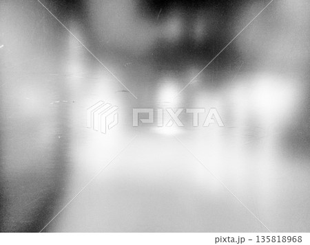 Dirty mirror or glass surface with reflections and a blurry background. 135818968