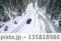 Aerial View of Car Driving on Snowy Winding Road Next to Frozen River Aerial View of Car Driving on Snowy Winding Road Next to Frozen River 135818980