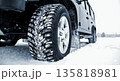 Close-Up of Heavy Duty Off-Road Winter Tire on Snowy Ground Close-Up of Heavy Duty Off-Road Winter Tire on Snowy Ground 135818981