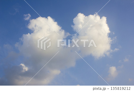 It's a blue sky with atmospheric puffy clouds. It's a blue sky with atmospheric puffy clouds. 135819212