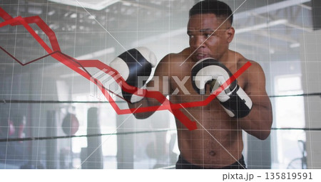 Practicing boxer throwing punch in boxing ring at gym, with gloves ropes red line graph overlay 135819591