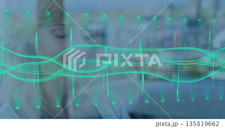Standing woman wearing sweater closing eyes behind glass in office, turquoise waveform, copy space 135819662