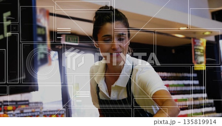 Leaning store clerk handing item over retail counter in supermarket, with striped apron, exit sign Leaning store clerk handing item over retail counter in supermarket, with striped apron, exit sign 135819914