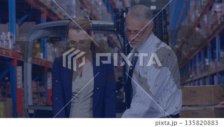 Discussing logistics business professionals reviewing inventory at warehouse aisle, with clipboard Discussing logistics business professionals reviewing inventory at warehouse aisle, with clipboard 135820883