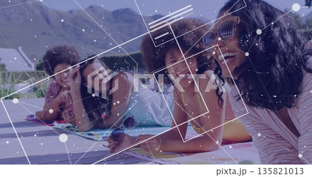 Four friends in swimwear lying and chatting on pool deck, with towels, sunglasses, network overlay Four friends in swimwear lying and chatting on pool deck, with towels, sunglasses, network overlay 135821013