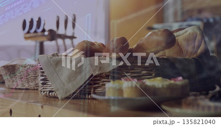 Showcasing wicker basket holding bread loaves and baguettes in bakery, with frosted cupcakes Showcasing wicker basket holding bread loaves and baguettes in bakery, with frosted cupcakes 135821040