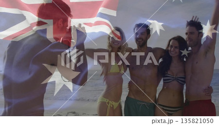 Posing five friends wearing bikinis, swim trunks at beach, with camera and Australian flag overlay 135821050