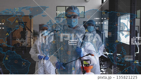Spraying disinfection crew clad in white coveralls in lab, with spray wand, tank, map overlay 135821225
