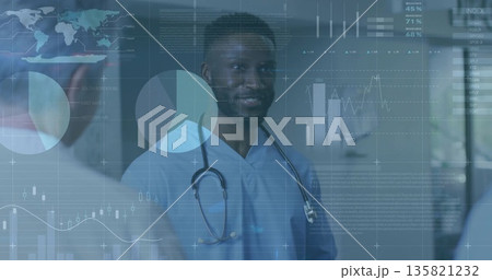 Reassuring doctor in scrubs talking with patient in medical corridor, with stethoscope and overlays 135821232