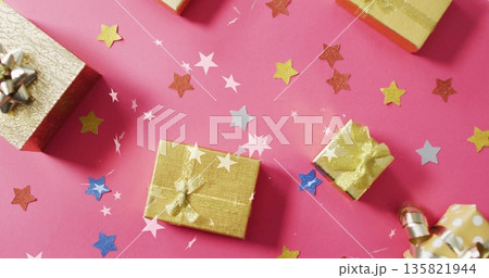 Gift boxes with ribbons over star confetti image on pink background 135821944