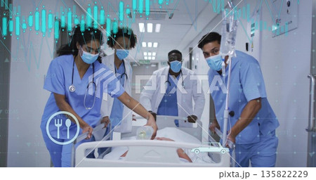 Moving medical team in blue scrubs guiding patient on gurney down hospital corridor, with Ambu bag Moving medical team in blue scrubs guiding patient on gurney down hospital corridor, with Ambu bag 135822229