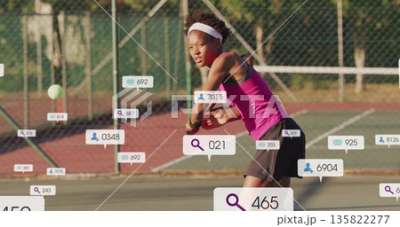 Swinging female tennis player holding racket, returning ball on outdoor court, wearing pink top Swinging female tennis player holding racket, returning ball on outdoor court, wearing pink top 135822277