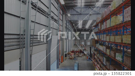 Featuring blue orange pallet rack storing boxes and wrapped pallets in warehouse, copy space 135822301