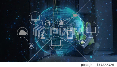 Kneeling technician in vest connecting cables in data center, with digital globe icons, copy space 135822326
