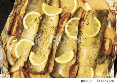 Prerape raw spiced hake for a bake in the oven with lemon, tomatoes, carrots, and onions in foil. Delicious fish for lunch or dinner, perfect for a diet. Tasty and fresh hake fish for bake with Prerape raw spiced hake for a bake in the oven with lemon, tomatoes, carrots, and onions in foil. Delicious fish for lunch or dinner, perfect for a diet. Tasty and fresh hake fish for bake with 135823120
