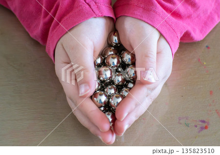 Child having fun with an authentic leisure activity, fine motor skills development Child having fun with an authentic leisure activity, fine motor skills development 135823510