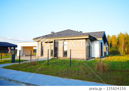 Suburban residential neighborhood, home on street, fence of single family home. Suburb family house 135824150