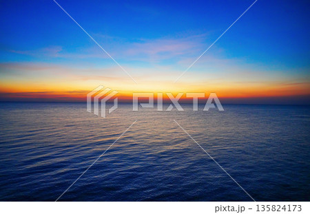 Sunset sea at evening night. Sunset over ocean with blue sky orange horizon at evening time. Sunset sea at evening night. Sunset over ocean with blue sky orange horizon at evening time. 135824173