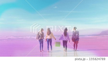Walking four friends carrying beige tote, pink object, green box, brown purse on low tide shoreline Walking four friends carrying beige tote, pink object, green box, brown purse on low tide shoreline 135824789