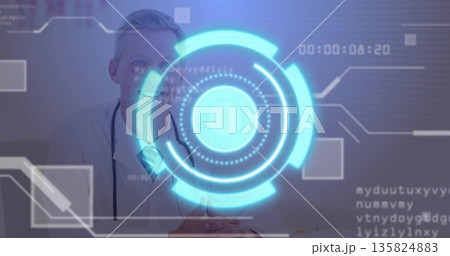 Sitting white coat doctor reviewing holographic data at desk in clinic room, with stethoscope Sitting white coat doctor reviewing holographic data at desk in clinic room, with stethoscope 135824883