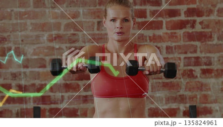 Lifting dumbbells to shoulder woman in red sports bra, brick studio with graph overlays Lifting dumbbells to shoulder woman in red sports bra, brick studio with graph overlays 135824961