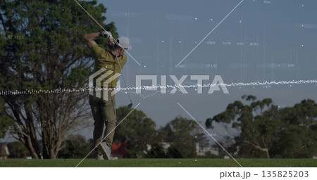 Swinging mature golfer finishing swing on fairway, with golf club, golf glove and data overlay 135825203