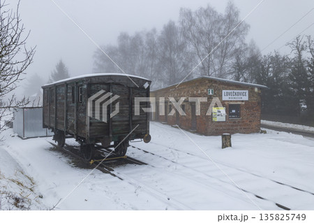 Abandoned train wagon at Loveckovice station in winter 135825749
