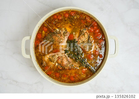Cooking stew with rabbit meat and vegetables in a pot on stovetop Cooking stew with rabbit meat and vegetables in a pot on stovetop 135826102