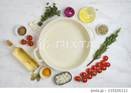 Preparing for a cooking session with fresh ingredients and empty cookware on a kitchen countertop Preparing for a cooking session with fresh ingredients and empty cookware on a kitchen countertop 135826112