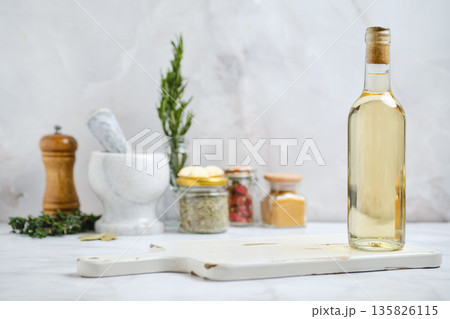 Bottle of oil with herbs and spices in a kitchen setting Bottle of oil with herbs and spices in a kitchen setting 135826115