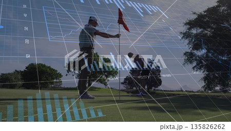 Holding flagstick, two golfers crouching and placing golf ball on putting green, with data overlays 135826262