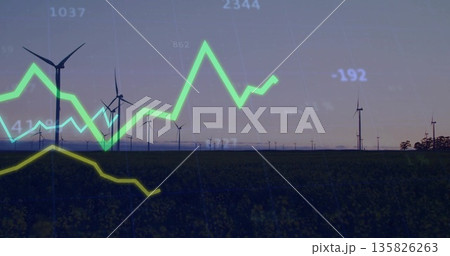 Displaying wind turbines stretching across field at dusk, with glowing green and yellow line graphs 135826263