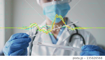 Holding swab and sample tube nurse wearing lab coat with stethoscope viewing data overlay in clinic 135826568