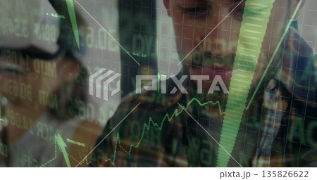 Analysts in glasses scanning stock graphs in office with green codes on glass screen, copy space Analysts in glasses scanning stock graphs in office with green codes on glass screen, copy space 135826622