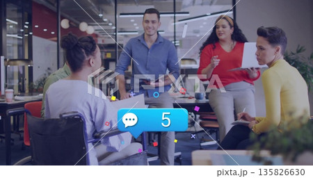 Discussing group of professionals collaborating around table in open office, with wheelchair Discussing group of professionals collaborating around table in open office, with wheelchair 135826630